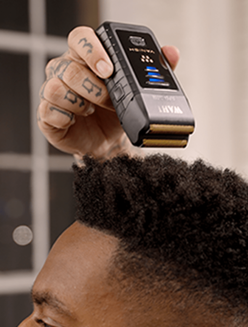 Barber using Wahl Vanish shaver to finish the haircut
